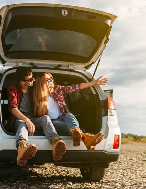 Couple sitting in back of car.