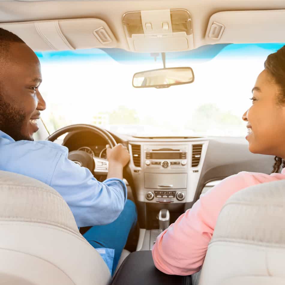 Young couple in new car.