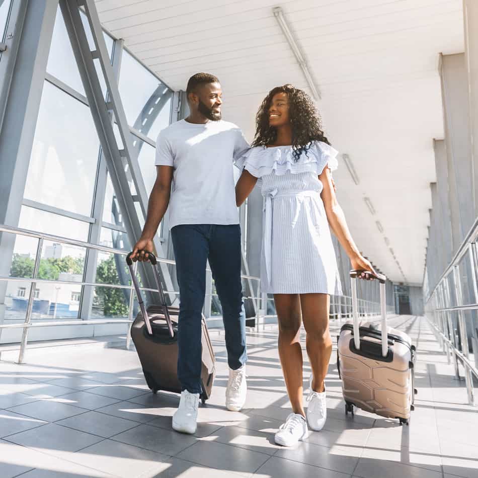Couple in airport leaving for vacation.